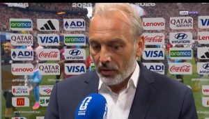 This image shows Sébastien Desabre, the head coach of the DR Congo national football team, speaking at a press conference following a 2026 World Cup match.